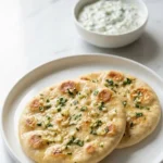 10-Minuten-Fladen serviert mit Tzatziki-Dip — mediterrane Servierszene auf weißem Marmor